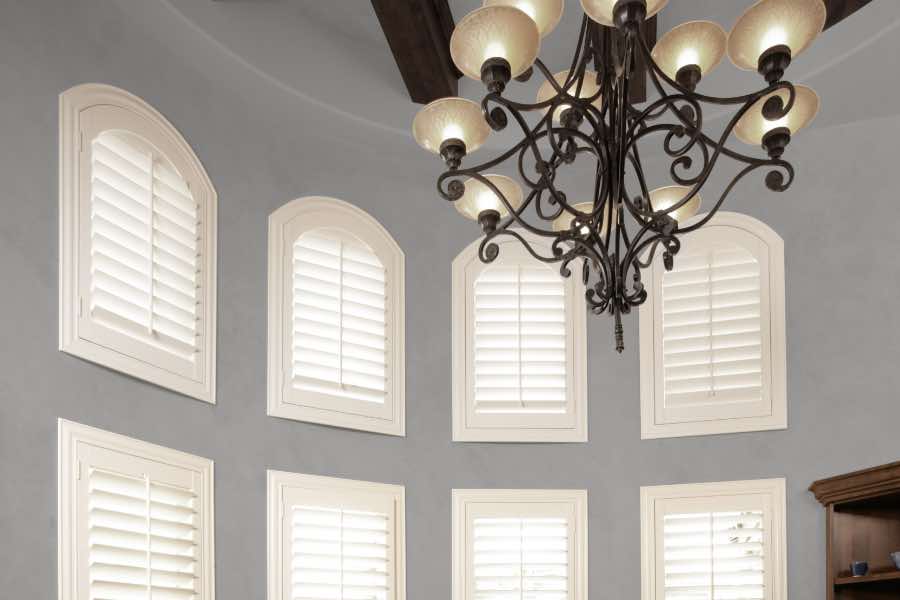 Polywood shutters on several small arched windows